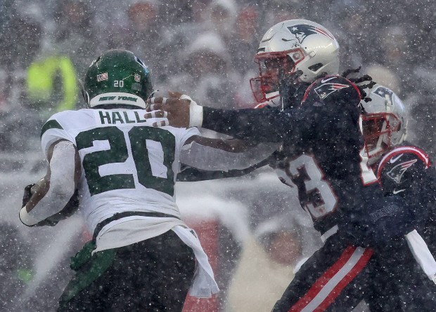 New York Jets running back Breece Hall stiff-arms New England Patriots safety Kyle Dugger during the second quarter of a game at Gillette Stadium. (Nancy Lane/Boston Herald)