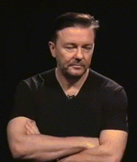 Ricky-Gervais-Holding-in-Laughter-Arms-Crossed.gif