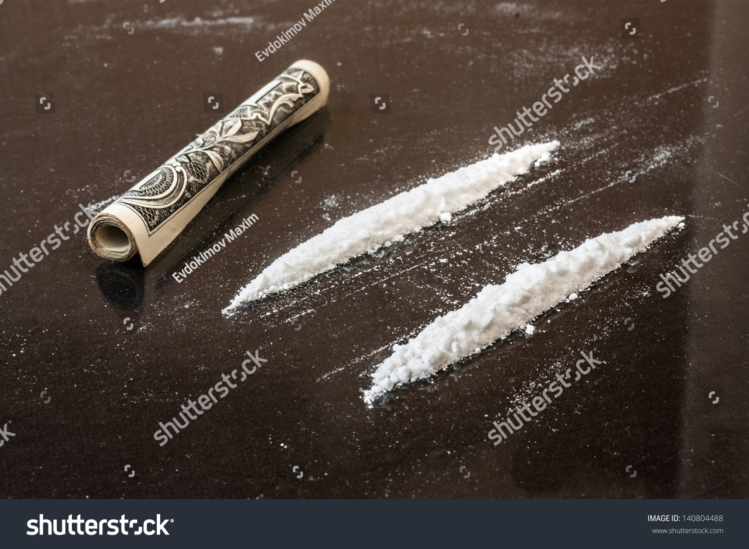 stock-photo-two-line-of-cocaine-beside-a-wrapped-up-dollar-bill-credit-card-140804488.jpg