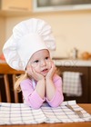 3297263-74121-little-cook-girl-sitting-at-kitchen-table-waiting-for-meal.jpg