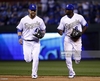 alex-gordon-and-lorenzo-cain-of-the-kansas-city-royals-jog-off-the-picture-id518998136.jpg