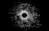 9162407-bullet-hole-in-glass-real-bullet-hole-closeup-and-isolated-on-black.jpg