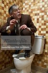700-00515691em-Man-Hiding-in-Washroom-Sneaking-A-Cigarette.jpg