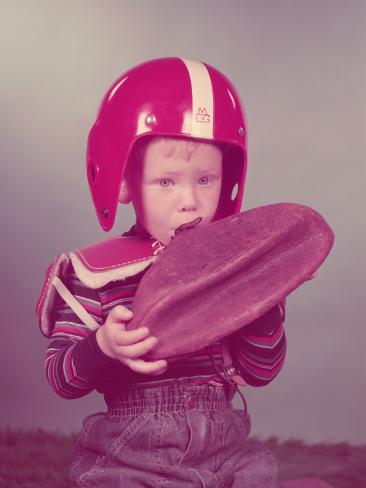 h-armstrong-roberts-boy-trying-to-blow-up-american-football.jpg