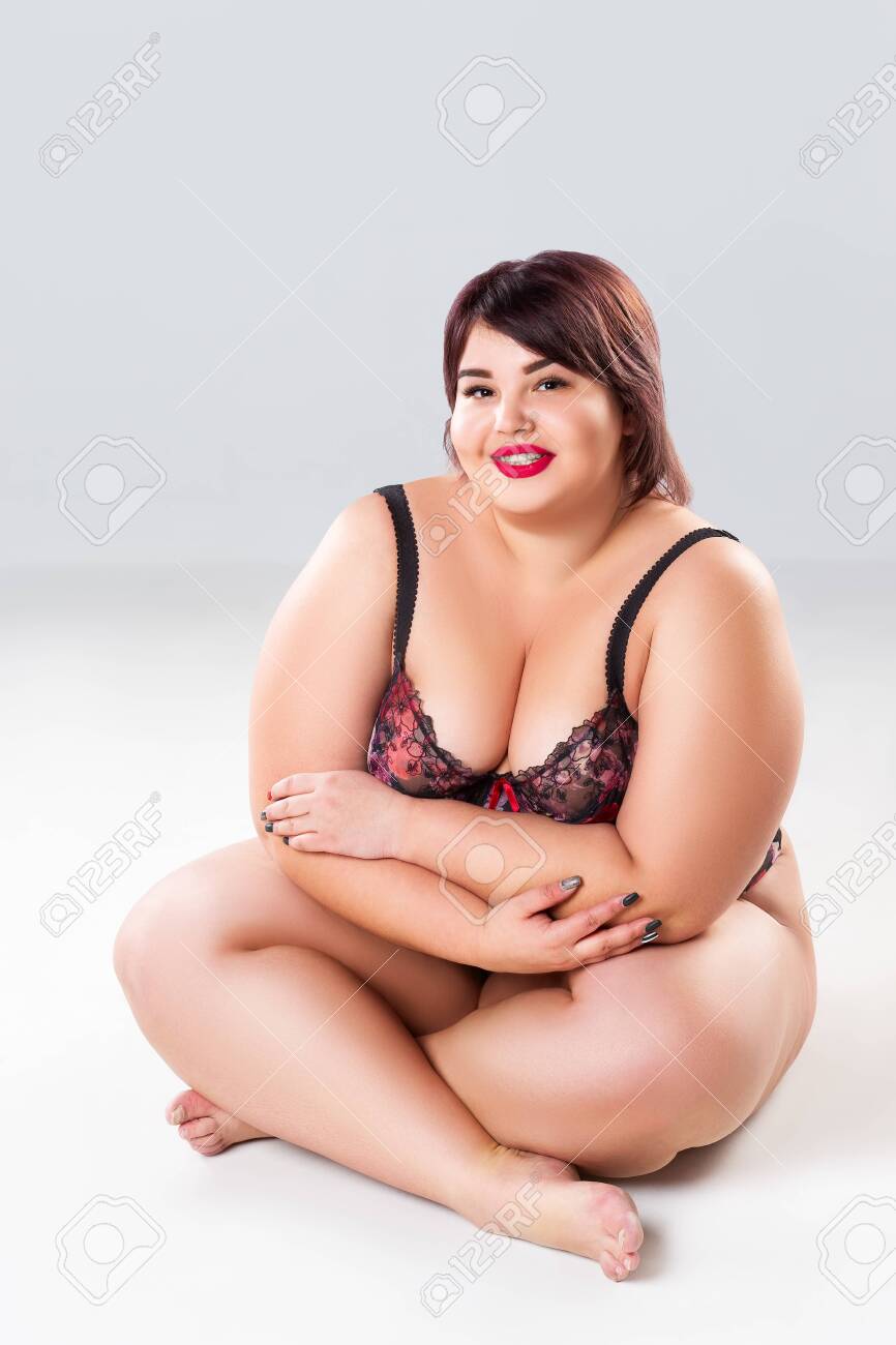 Plus size model in lace lingerie, fat sexy woman in underwear on gray background, body positive concept - 142540015