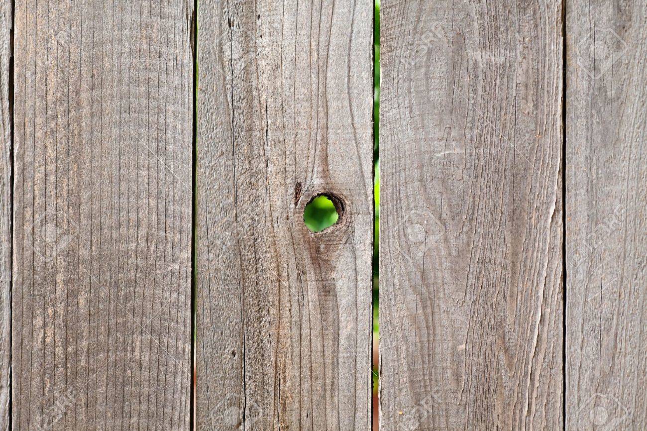 5140929-rough-wooden-fencing-background-with-knot-hole-Stock-Photo.jpg