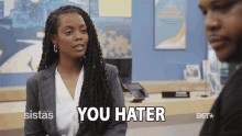 a woman says you hater in front of a bet logo
