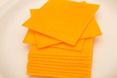 sliced-cheddar-cheese-white-plate-cheeses-49453216.jpg