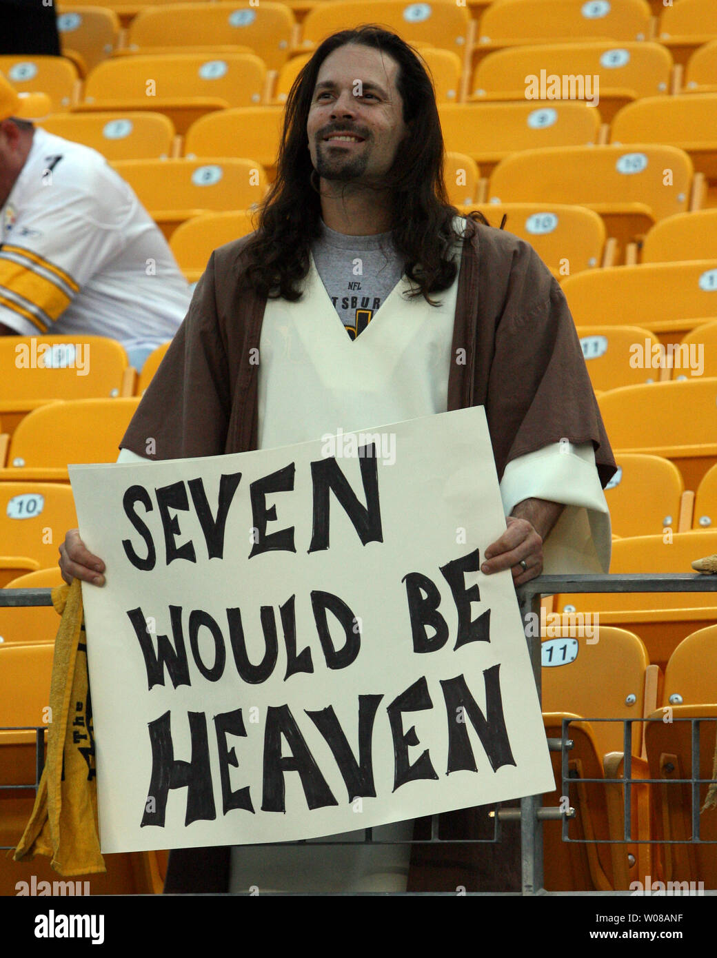a-pittsburgh-steelers-fan-dressed-as-jesus-holds-a-sign-up-before-the-start-of-the-game-against-the-tennessee-titans-at-heinz-field-during-on-september-10-2009-upi-photostephen-gross-W08ANF.jpg