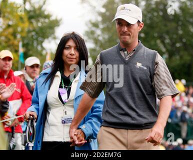 international-team-golfer-mike-weir-of-canada-walks-with-his-wife-bricia-after-his-second-round-four-ball-match-at-the-presidents-cup-golf-tournament-at-the-royal-montreal-golf-club-september-28-2007-reutersshaun-best-canada-2d2em7g.jpg