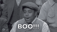 SNL gif. Black and white. Kenan Thompson, wearing a pageboy hat and old-timey clothes, yells, Boo!!!