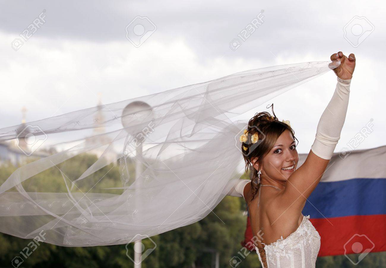 21027769-the-happy-bride-on-a-background-of-the-russian-flag.jpg
