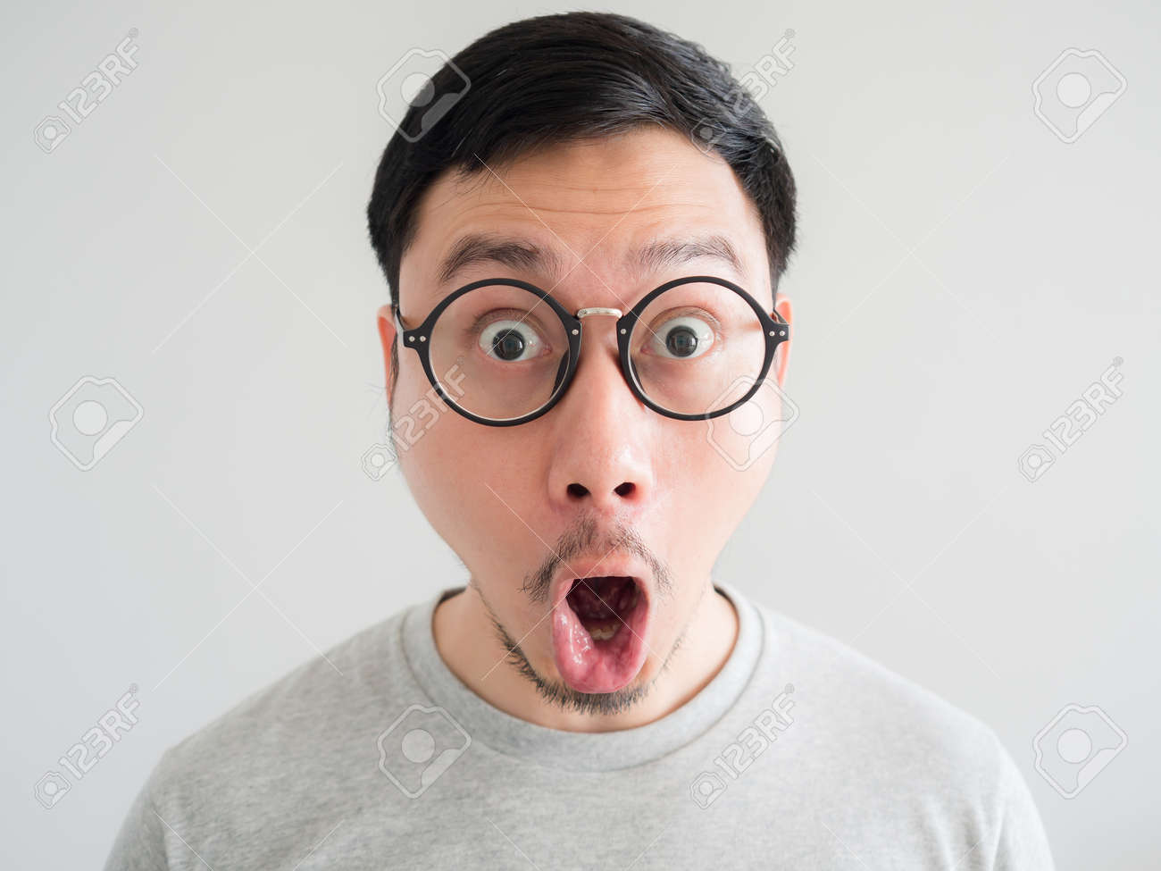 101181979-amazing-and-shocked-face-of-asian-man-with-eyeglasses-.jpg