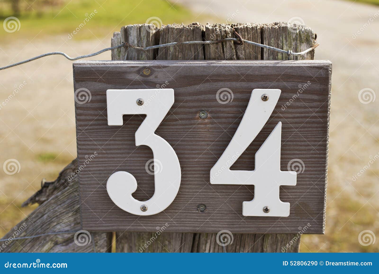 house-number-wooden-sign-white-letters-wooden-fence-background-52806290.jpg