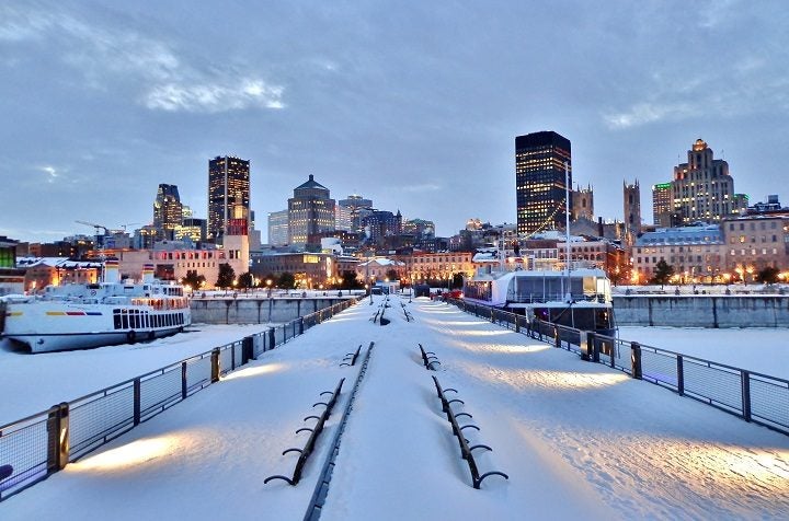 MOntreal_Snow-covered-benches-pier-waterfront-walkway-harbour-and-downtown-Montreal-after-sunset-in-winter-Montreal-Canada-720x476.jpg